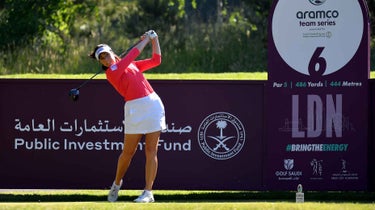 Georgia Hall tees off in front of the Aramco Team Series sign