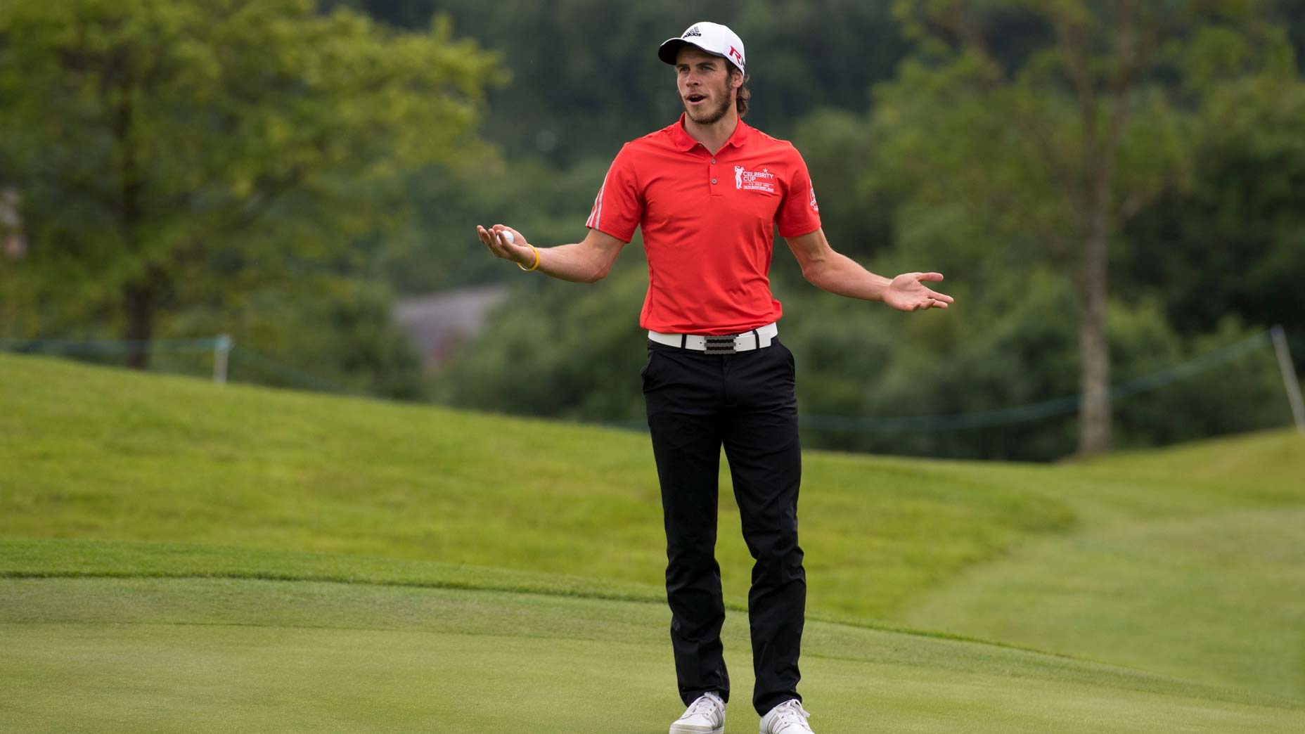 Footballer Gareth Bale gestures to the crowd during the annual Celebrity Cup golf tournament at Celtic Manor Resort on July 4, 2015 in Newport, Wales. The Celebrity Cup sees celebrities from England, Wales, Ireland and Scotland competing against each other.