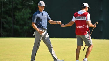 Michael Thorbjornsen (A) gives knuckles to his caddie while walking off the 14th green during the final round of the Travelers Championship at TPC River Highlands on June 26, 2022 in Cromwell, Connecticut.