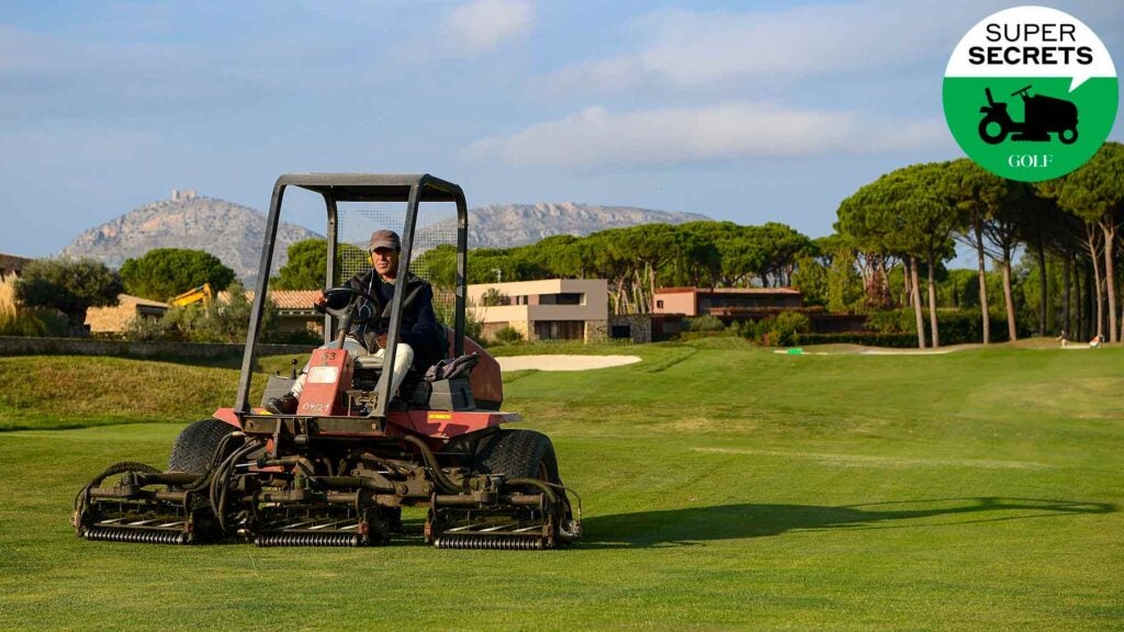 a man mows on a golf course