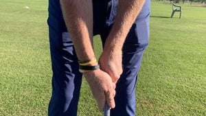 A golfer grips a club