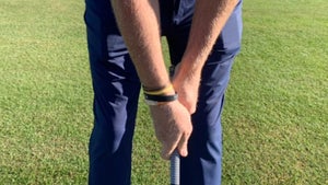 A golfer grips a club