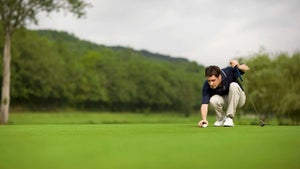 a golfer reads a putt