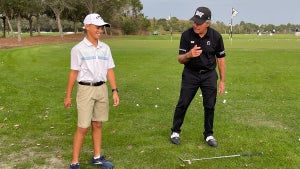 Gary Player gives a young fan a chipping lesson