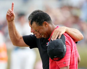 Tiger Woods of USA walks off the 18th green in tears with his caddy Steve Williams following his victory at the end of the final round of The Open Championship at Royal Liverpool Golf Club on July 23, 2006 in Hoylake, England.