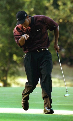 Tiger Woods reacts after making a putt on the first hole of the playoff August 20, 2000 during the PGA Championship at the Valhalla Golf Club in Louisville, Ky. Woods defeated Bob May in the playoff to win the tournament, becoming the first player since Ben Hogan in 1953 to win three majors in one year.