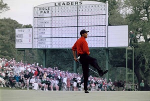 Tiger Woods of the United States celebrates after sinking a 4 feet putt to win the US Masters Golf Tournament with a record low score of 18 under par 13 April 1997 at the Augusta National Golf Club in Augusta, Georgia, United States.