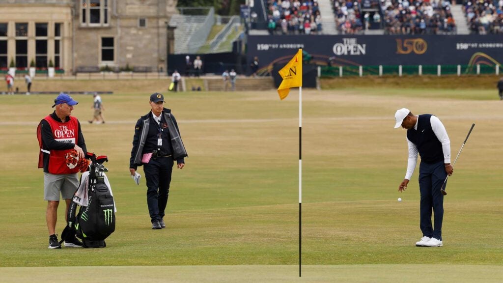 Tiger Woods of the United States drops their ball on on the 1st hole the during Day One of The 150th Open at St Andrews Old Course on July 14, 2022 in St Andrews, Scotland.