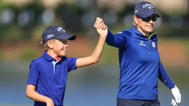 Annika Sorenstam of Sweden holds hands with her son Will McGee as they walk down the 18th hole during the final round of the 2022 PNC Championship at The Ritz-Carlton Golf Club on December 18, 2022 in Orlando, Florida.