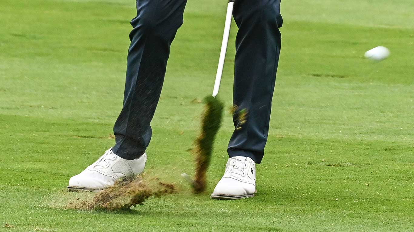 golfer taking divot