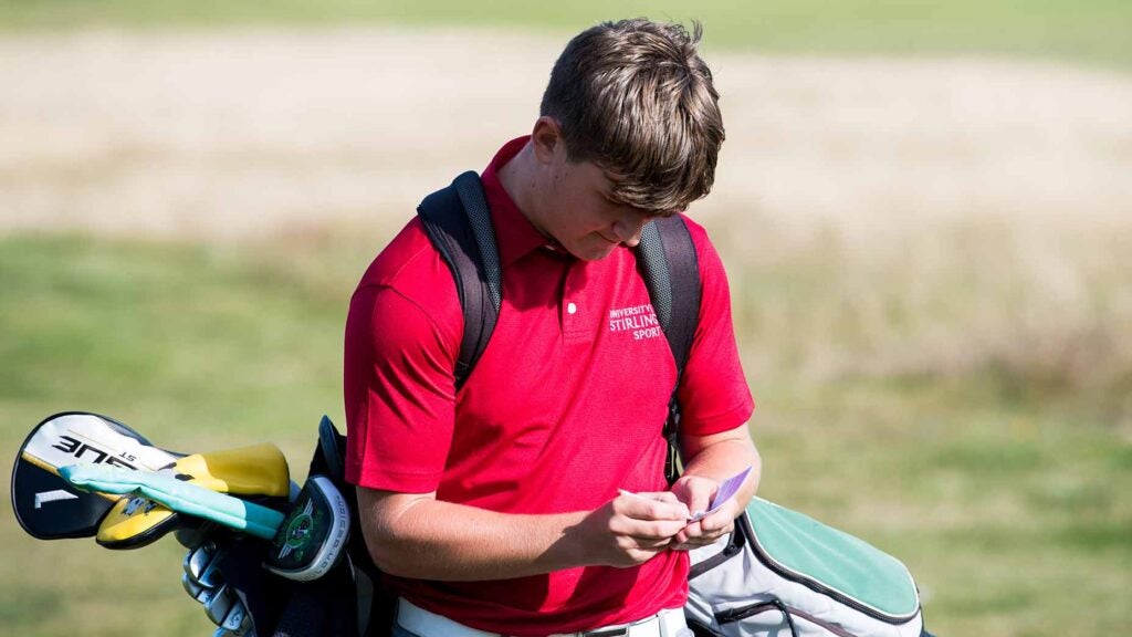 boy signs scorecard