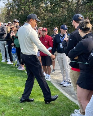 Tiger giving a young fan a fist-bump
