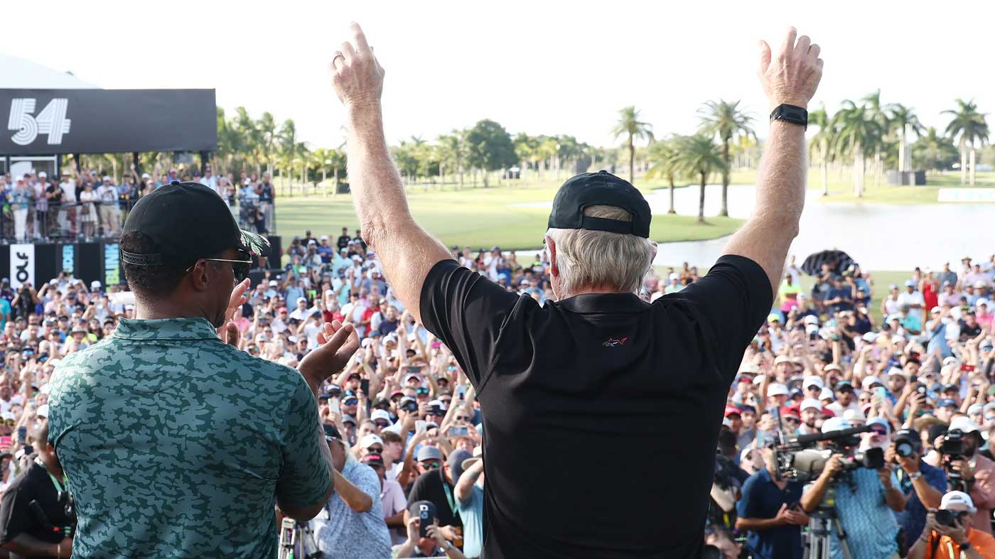 Majed Al Sorour, CEO of Saudi Golf Federation, and Greg Norman, CEO and commissioner of LIV Golf, cheer on stage after the team championship stroke-play round of the LIV Golf Invitational - Miami at Trump National Doral Miami on October 30, 2022 in Doral, Florida.