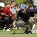 Mike Weir and Tiger Woods line up putts at 2007 Presidents Cup