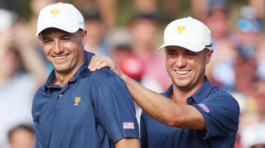 Justin Thomas (R) of the United States Team celebrates with teammate Jordan Spieth (L) after Spieth holed out on the 15th green to win the match 4&3 over Hideki Matsuyama of Japan and Taylor Pendrith of Canada and the International Team during Saturday afternoon four-ball matches on day three of the 2022 Presidents Cup at Quail Hollow Country Club
