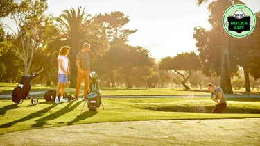 golfer hits bunker shot