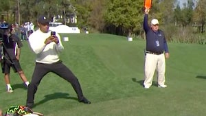 tiger takes a video of his son charlie's swing