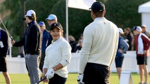 Charlie Woods smiles at his dad, Tiger Woods, on the driving range.