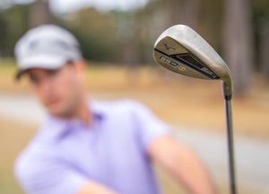 The author plays a shot with a Mizuno S23 sand wedge.