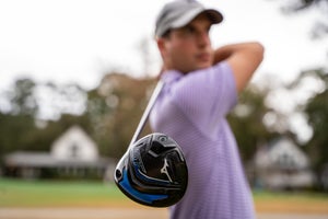 The author plays a shot with a Mizuno ST 230 Z driver.