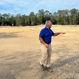 Architect Mike Nuzzo stands on the fifth green at The Ace
