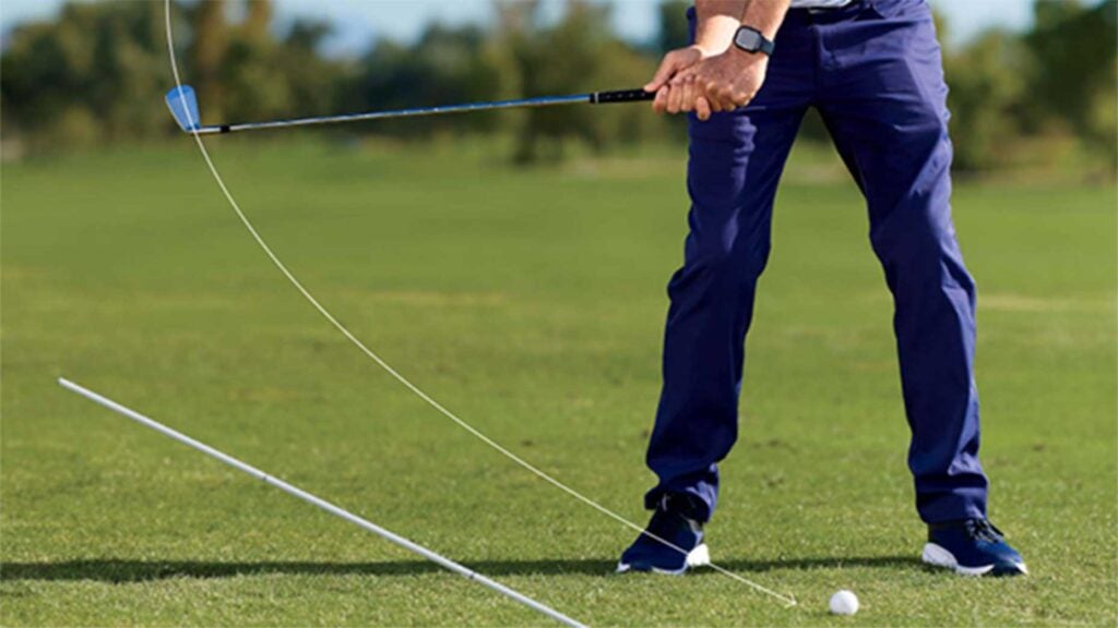 a golfer compresses the golf ball