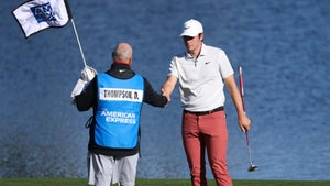 Davis Thompson shakes hand with caddie on green at 2023 American Express