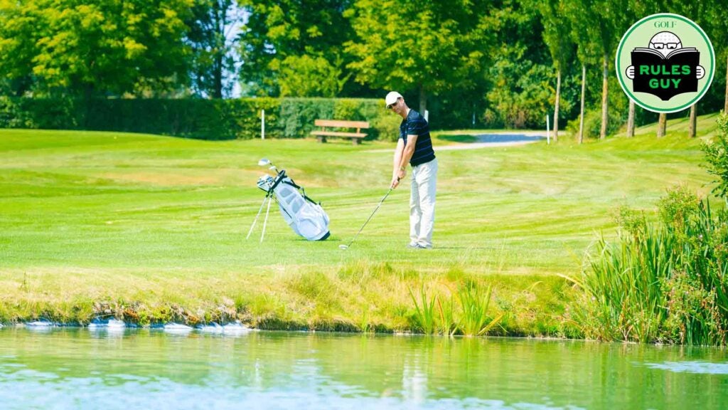 golfer next to water hazard