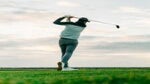 Golfer holding swing finish