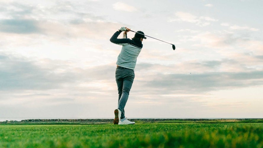 Golfer holding swing finish