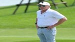 greg norman stands at tournament
