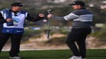 Justin Rose of England reacts with his caddie Josh Cassell after his putt on the sixth green during the final round of the AT&T Pebble Beach Pro-Am at Pebble Beach Golf Links on February 05, 2023 in Pebble Beach, California.