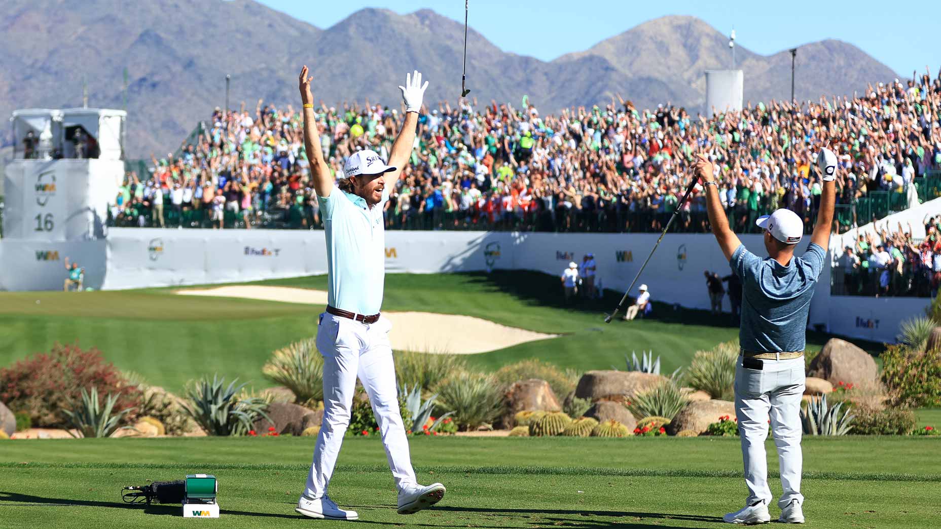 Sam Ryder of the United States reacts to his hole-in-one with Brian Harman of the United States on the 16th hole during the third round of the WM Phoenix Open at TPC Scottsdale on February 12, 2022 in Scottsdale, Arizona.