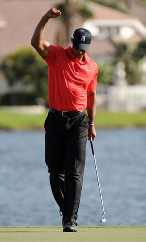 Tiger Woods celebrates an eagle at the 18th hole at the Honda Classic at PGA National Resort & Spa in Palm Beach Gardens, Florida, on Sunday, March 4, 2012.