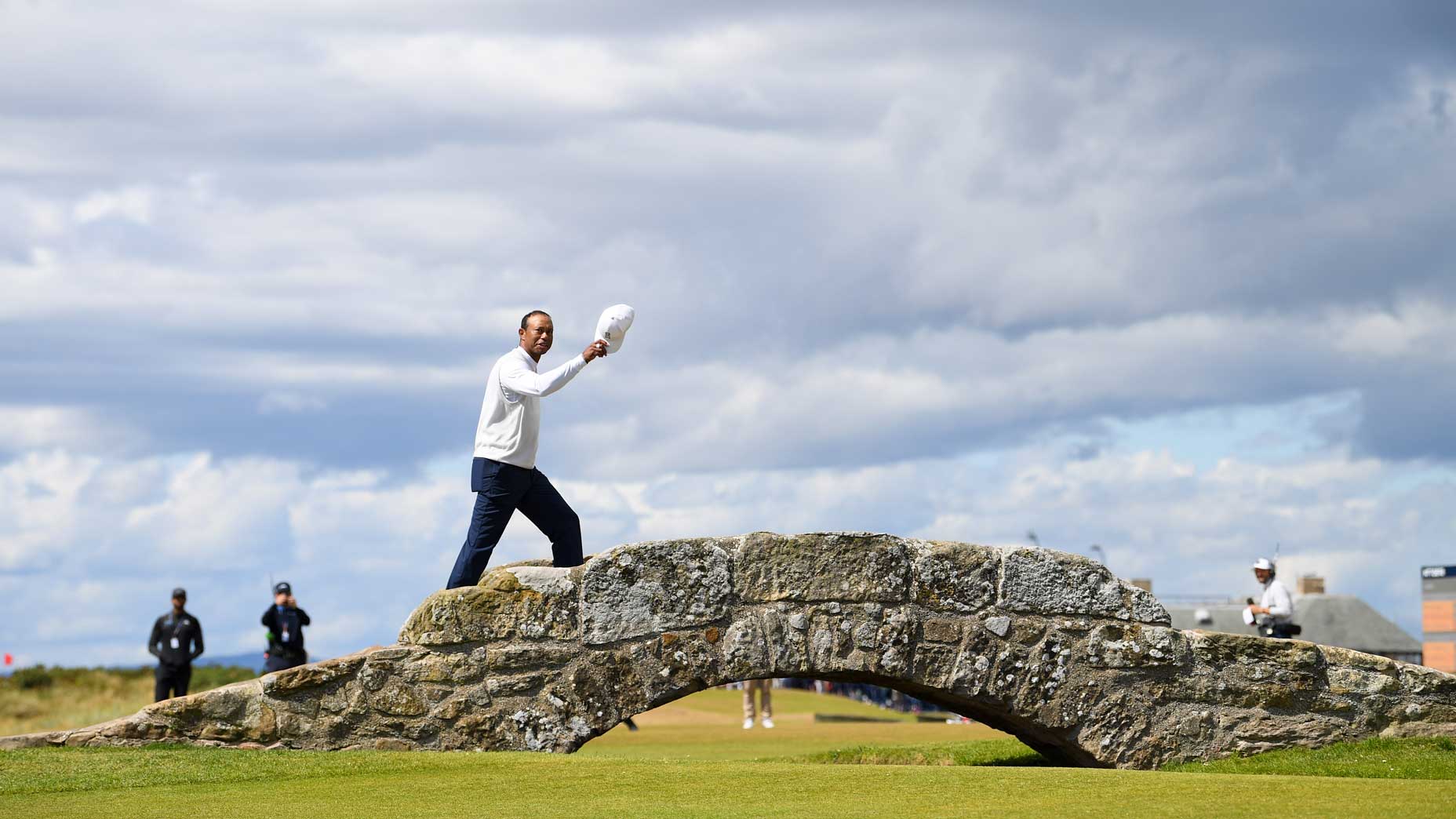 Tiger Woods of the United States acknowledges the crowd as he crosses the Swilcan Bridge during Day Two of The 150th Open at St Andrews Old Course on July 15, 2022 in St Andrews, Scotland.