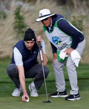 Pau Gasol reads a putt at the AT&T Pebble Beach Pro-Am.