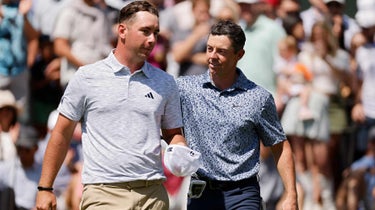 Lucas Herbert of Australia (L) and Rory McIlroy of Northern Ireland meet on the 18th green after McIlroy won their match 2 up during day four of the World Golf Championships-Dell Technologies Match Play at Austin Country Club on March 25, 2023 in Austin, Texas.