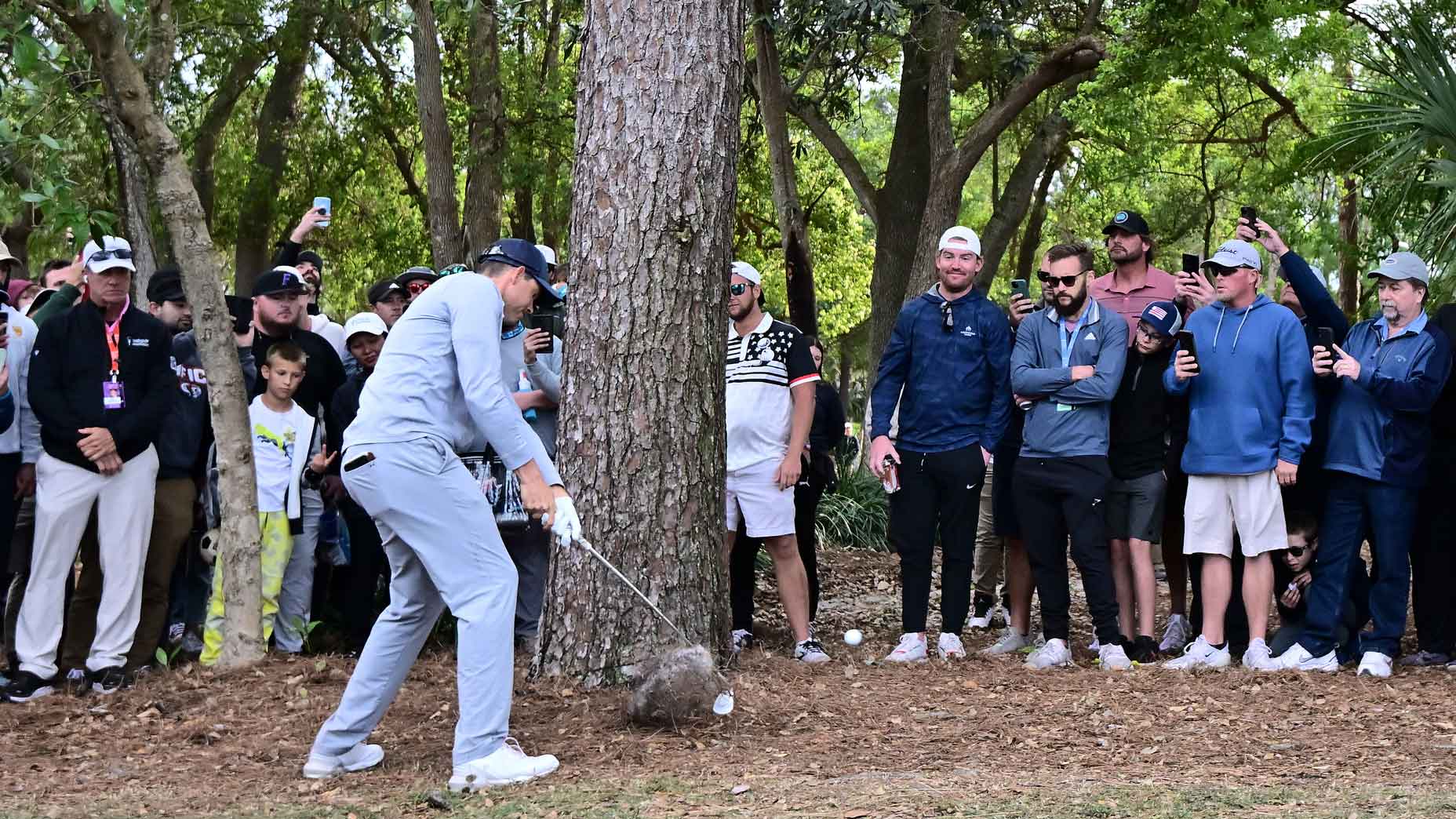 Adam Schenk of the United States plays an approach shot on the 18th hole as fans look on during the final round of the Valspar Championship at Innisbrook Resort and Golf Club on March 19, 2023 in Palm Harbor, Florida.