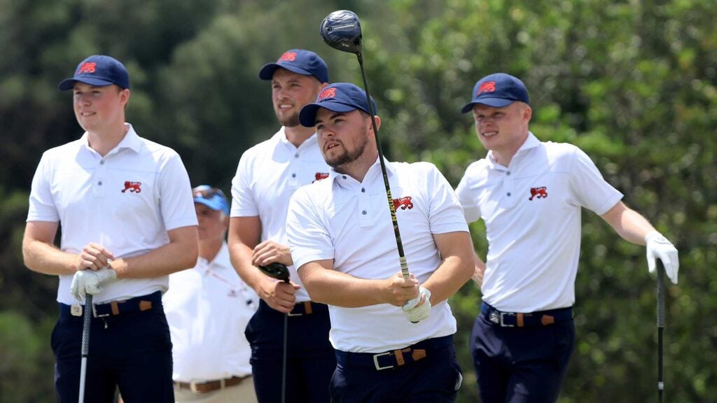 Alex Fitzpatrick of the Great Britain and Ireland Walker Cup team plays a shot as Mark Power, Angus Flanagan, and Matty Lamb look on during a practice day prior to The Walker Cup at Seminole Golf Club on May 07, 2021 in Juno Beach, Florida.