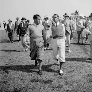 Bobby Jones walks with Paul Runyan at the 1934 Masters.