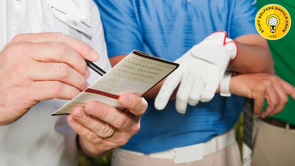 golfers writing down their scores