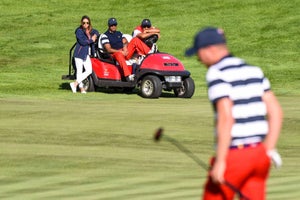 Captain's Assistant Tiger Woods and Notah Begay watch Daniel Berger of the U.S. Team putt on the 15th hole green during Sunday Singles matches at the Presidents Cup at Liberty National Golf Club on October 1, 2017, in Jersey City, New Jersey.