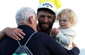 AUGUSTA, GEORGIA - APRIL 09: Jon Rahm of Spain celebrates with his son Kepa Cahill Rahm and his father, Edorta Rahm, on the 18th green after winning the 2023 Masters Tournament at Augusta National Golf Club on April 09, 2023 in Augusta, Georgia. (Photo by Patrick Smith/Getty Images)