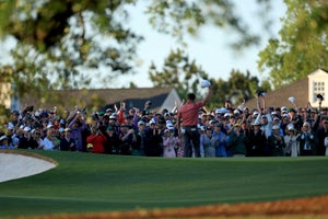 AUGUSTA, GEORGIA - APRIL 09: Jon Rahm of Spain waves to the patrons after holing the winning putt on the 18th green as his caddie Adam Hayes looks on during the final round of the 2023 Masters Tournament at Augusta National Golf Club on April 09, 2023 in Augusta, Georgia. (Photo by David Cannon/Getty Images)