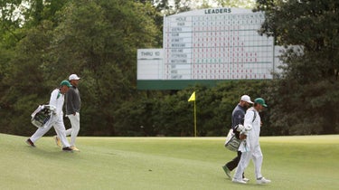 Brooks Koepka and Jon Rahm walk to the 12th tee during the third round of the Masters on Sunday.