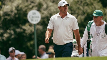 brooks koepka walks with his caddie