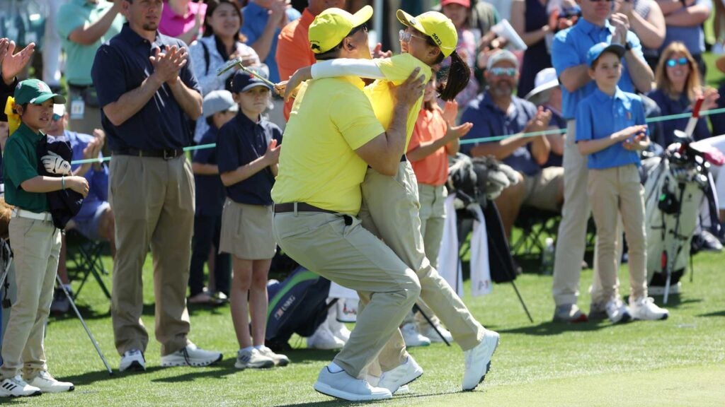 a father and daughter hug at augusta national