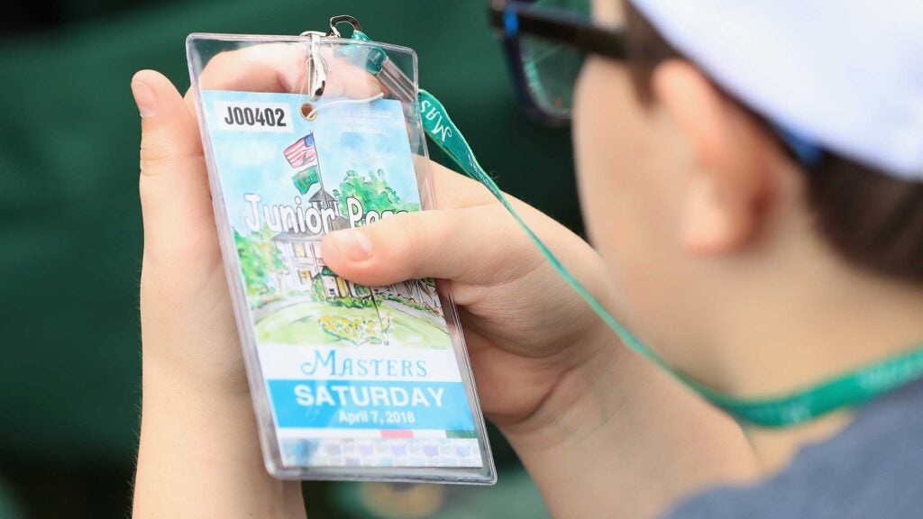 a man looks at masters tickets