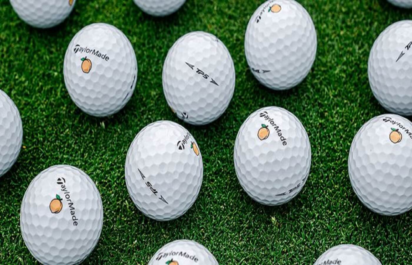 TaylorMade golf balls laying on grass