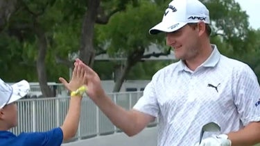 Emiliano Grillo invited two fans to hit balls with him as he waited for the playoff to begin at the Charles Schwab Challenge.